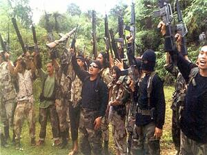 Abu Sayyaf militants raise their weapons. (AFP/File)