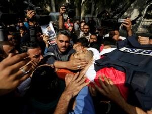 Mourners and journalists carry the body of Palestinian journalist Yasser Murtaja, during his funeral in Gaza. The Israeli army admitted he was shot dead despite posing no threat. (AFP/File Photo)	
