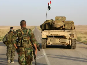 Syrian soldier walk behind a military vehicle (AFP/File Photo)	