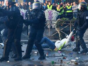 A policeman evacuates a demonstrator in Quimper, western France, during a nationwide day of protest. (AFP)