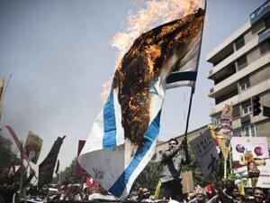 File photo of an Israeli flag burning. (AFP/File)
