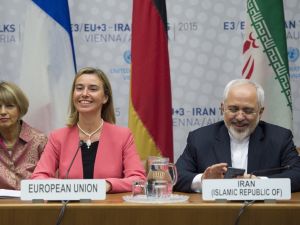 Iranian Foreign Minister Mohammad Javad Zarif speaks next to European Union High Representative for Foreign Affairs and Security Policy Federica Mogherini during a plenary session at the United Nations building in Vienna, Austria on July 14, 2015 (AFP)