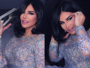 اختارت أحلام لإطلالتها فستان باللون الفضي الضارب على بنفسجي