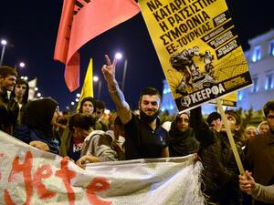 A Syrian man flashes a victory sign during a demonstration by in Greece stranded refugees and supporting groups in Athens on March 30, 2016. (AFP/Louisa Gouliamaki)