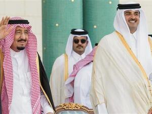 A handout picture provided by the Saudi Royal Palace on December 5, 2016 shows Saudi King Salman (L) waiving next to the Emir of Qatar Sheikh Tamim bin Hamad Al Thani during a ceremony in Doha. (AFP)