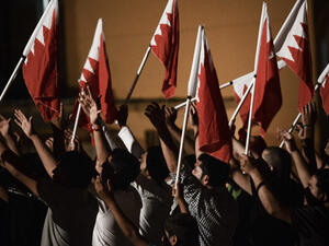 Protesters hold Bahraini flags. (AFP/File)