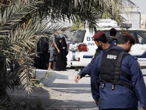 Bahraini police stand near the site of a bomb blast in a village south of Manama, on Dec. 9, 2014. (AFP/Mohammed al-Shaikh)