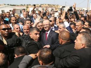 Palestinian Authority Prime Minister Rami Hamdallah is surrounded by security (AFP/File Photo)	