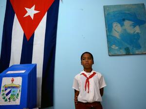 A schoolboy stands at a polling station in Havana during elections (AFP/File Photo)