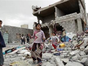 Children walk through the rubble after an airstrike in Sana'a, north of Taiz. (AFP/File)