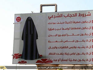 A Daesh bilboard in Sirte, Libya, describing how women must be dressed. (AFP/File)