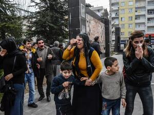 People disperse as Turkish police fire tear gas in Diyarbakir on February 27, 2016 during a demonstration against government-imposed curfews on areas of eastern Turkey. (AFP/Ilyas Akengin)