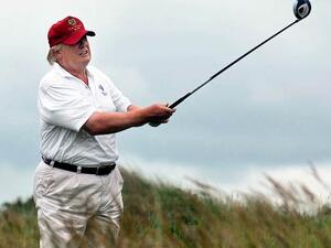 Donald Trump golfing. (AFP/ Andy Buchanan)