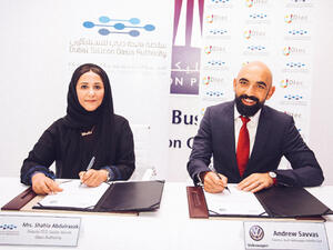 Shahla Ahmed Abdul Razak, deputy chief executive of DSOA, and Andrew Savvas, brand director of Volkswagen Middle East, during the signing ceremony. 