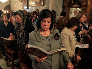 Palestinian Christian Catholics attend an Easter Vigil mass in Gaza City on April 8, 2012. (AFP/Mahmud Hams)