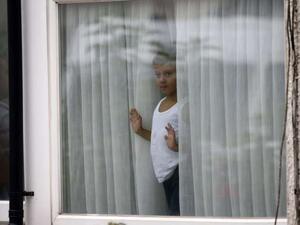 Child looking thru the window (AFP/File Photo)