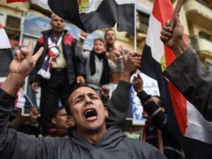 Egyptians holding national flags gather on Cairo's landmark Tahrir Square on January 25, 2016, as the country marks the fifth anniversary of the 2011 uprising. (AFP/File)
