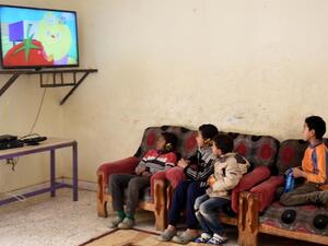 The mother stood with a poster advertising her three children for sale (AFP/File)