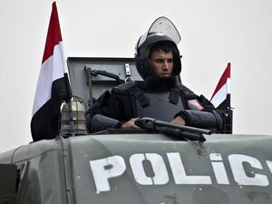 An Egyptian policeman stands guard from an armoured vehicle outside the venue of the trial of the ousted Islamist president Mohammed Morsi. (AFP/File)