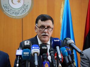 Libya's UN-backed Prime Minister-designate, Fayez al-Sarraj, flanked by members of the presidential council, speaks during a press conference on March 30, 2016 in the capital Tripoli. (AFP/Stringer)