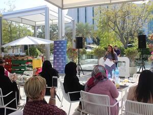 Female employee talking about her career journey during the event.
