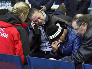 Relatives of the victims of the airplane crash speak with a Russian Emergency psychologist (L) at the airport in Rostov-on-Don on March 19, 2016. at the airport in Rostov-on-Don on March 19, 2016. (AFP/Sergei Venyavsky)