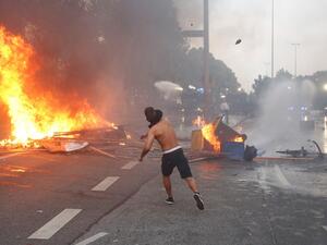 A protester throws a bottle at riot police in Hamburg last week. (Ronny Hartmann/ AFP)