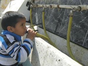 A Palestinian boy drinking water from a clean source in the Gaza Strip. (AFP/File)