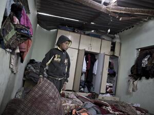 A Palestinian boy inspects a bedroom of the damaged Khussa family home after an Israeli strike on Hamas bases in Beit Lahiya, northern Gaza strip on March 12, 2016. (AFP/Mahmud Hams)