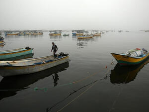 A Palestinian fisherman stands on his boat in Gaza City's seaport during heavy fog on February 26, 2017. (AFP/FILE) 