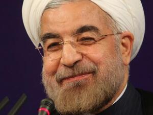RAN, Tehran : Iran's President Hasan Rowhani smiles as he adresses his first news conference since taking office, in Tehran, on August 6, 2013. Rowhani said that Iran was ready for "serious" talks on its nuclear programme without delay and that US calls for tougher sanctions showed a lack of understanding. AFP PHOTO/ATTA KENARE