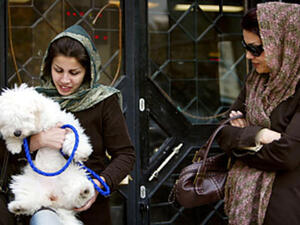 A woman enjoying her dog outdoors. [content.time]