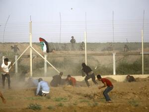 Israeli forces fire at Palestinians trying to cut border fence between Israel and Gaza Strip on Friday (AFP)