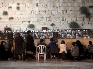 Orthodox Jewish women and men pray during the annual Tisha B'Av (Ninth of Av) fasting and a memorial day, commemorating the destruction of ancient Jerusalem temples some 2,000 years ago, at the Western Wall in Jerusalem's Old City on July 26, 2015. (AFP/Menahem Kahana)