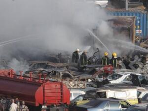 Firefighters extinguish the massive fire in the Customs Department yard in southern Amman that killed five people Monday. (Twitter)