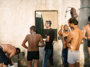 Showers of the makeshift refugee camp in the abandoned Hotel Captain Elias. August 2015 Greece, Europe. (©Jörg Brüggemann / OSTKREUZ)