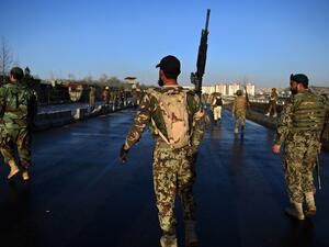 Afghan security personnel gather near the scene of a suicide bombing near the gate of Ministry of Defense in Kabul on February 27, 2016. (AFP/Wakil Kohsar)
