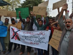 Pakistani demonstrators hold posters as they take part in a protest against Valentine's Day in Karachi on February 13, 2016. (AFP/Imran Ali)