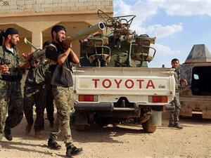 Kurdish and Arab forces hold rocket launchers as they prepare to confront Daesh on the outskirts of Manbij. (AFP/File)