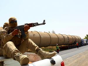 A guard at a Kurdish oil refinery. (AFP/Safin Hamed)