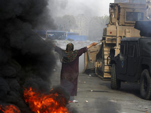 An Egyptian woman tries to stop a military bulldozer from going forward during clashes that broke out as Egyptian security forces moved in to disperse supporters of Egypt's deposed president Mohamed Morsi (AFP/MOHAMMED ABDEL MONEIM)