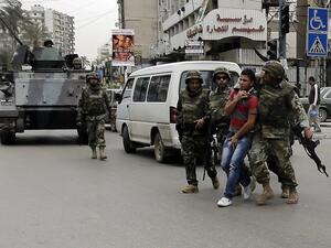 Lebanese soldiers arrest a man in Tripoli after fighting broke out in the city (AFP Photo)