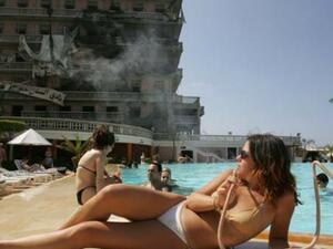 Visitors enjoy the swimming pool of Beirut's bombed landmark Saint-Georges Hotel. (AFP/File)