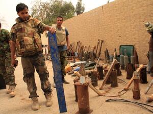 Forces loyal to the recognised parliament in the east of Libya collect improvised explosive devices (IED) on April 23, 2016, in the western suburbs of Benghazi. (AFP/Stringer)