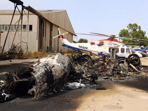A charred airplane lies on the ground at Tripoli international airport in the Libyan capital on July 14, 2014, following fighting between rival armed groups. (Mahmud Turkia/ AFP)