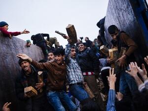 People rush to get firewood in a makeshift camp of the Greek-Macedonian border near the Greek village of Idomeni on March 6, 2016. (AFP/Dimitar Dilkoff)