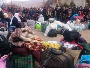 Residents of Madaya, one of Syria's besieged towns, are seen waiting to receive humanitarian aid. (File photo)