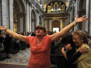 Faithful react after the announcement that Buenos Aires archbishop Jorge Mario Bergoglio was elected Pope Francis I, at Metropolitan Cathedral in Buenos Aires on Wednesday. (AFP PHOTO/JUAN MABROMATA)