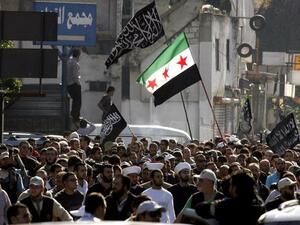 Protestors hold a Syrian pre-Baath flag during a demonstration lead by Lebanese Salafis on Sunday in Southern Lebanon. (AFP PHOTO/MAHMOUD ZAYYAT)
