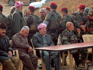 Massud Barzani, the president of Iraq's autonomous Kurdistan region (C-bottom) sits amidst Kurdish peshmerga security forces during a visit to the disputed north Iraq province of Kirkuk. (AFP PHOTO/MARWAN IBRAHIM)